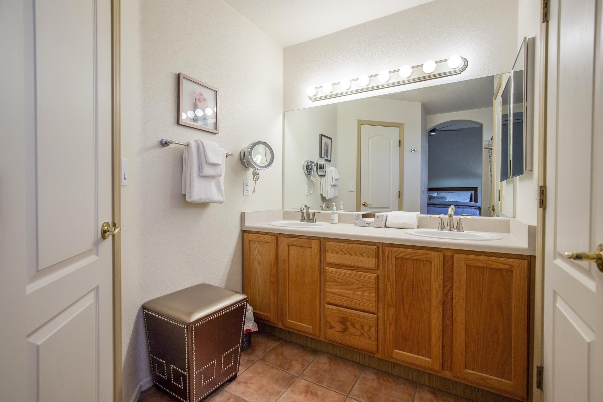 Ensuite bathroom with dual vanity sinks and a showertub combination.