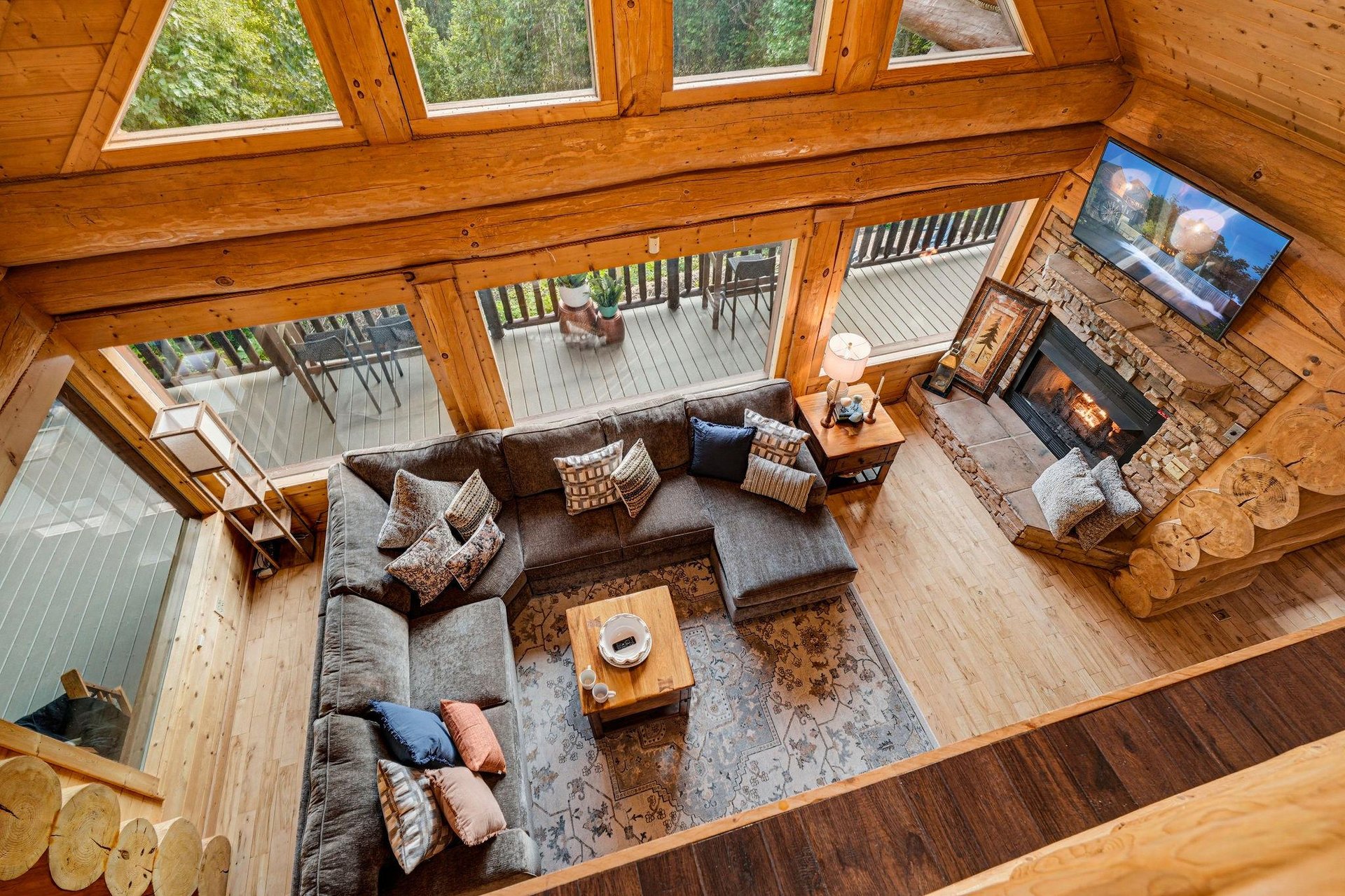 Sink into plush seating by the fireplace, surrounded by soaring wood beams and natural light. Step out to your private deck and breathe in the forest air.