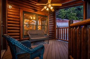Sink into your private wicker seating and take in the surrounding forest as evening light warms the handcrafted log walls around you.