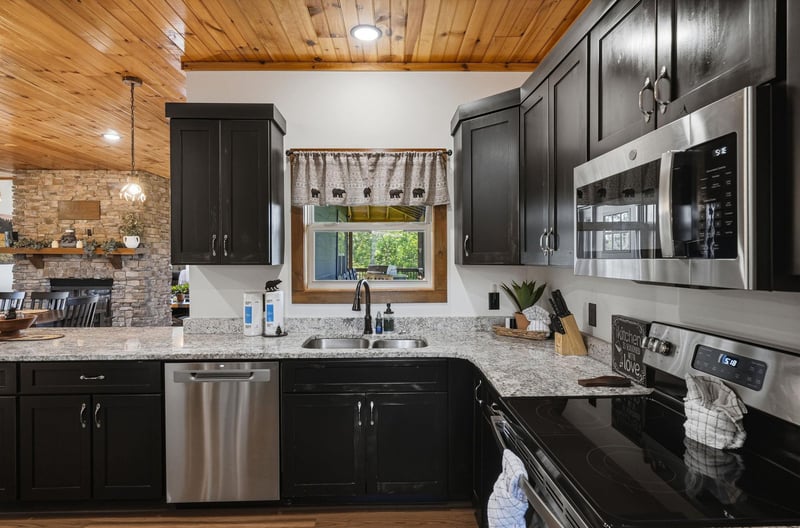 Cook your favorite meals in this fully equipped kitchen with sleek granite counters, stainless steel appliances, and warm woodbeam ceilings inviting you to gather and create.