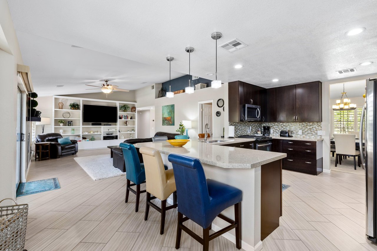 Stainless steel appliances, counter seating for 6, and cooking essentials.