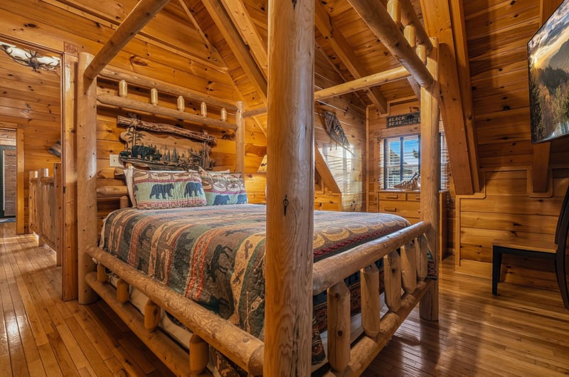 Your rustic log bedroom awaits with handcrafted furnishings, soaring timber ceilings, and warm wood tones that bring cozy mountain charm to your retreat.