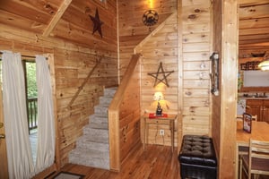 Staircase up to second floor at Bearly Mine, a 1bedroom cabin rental located in Pigeon Forge