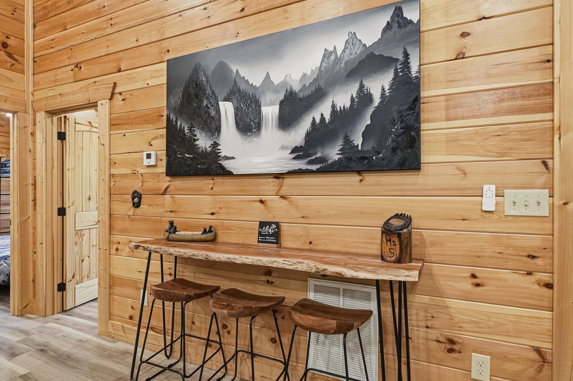 Warm wood tones and mountain artwork create your perfect spot to gather over morning coffee or plan the days adventures at this cozy barheight table.