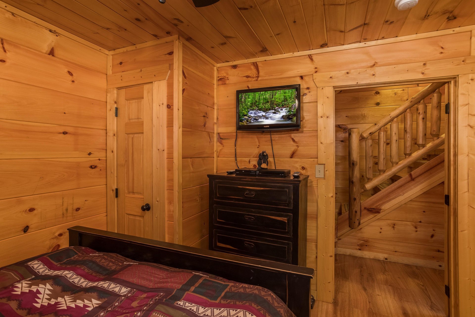 Dresser and TV in a bedroom at Graceland, a 4bedroom cabin rental located in Pigeon Forge