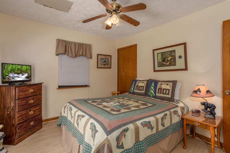 Bedroom with a dresser and fireplace at Black Bear Ridge, a 3bedroom cabin rental located in Pigeon Forge