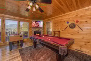 Game room with pool table, foosball, fireplace, and TV at Bears Dont Bluff, a 3 bedroom cabin rental located in Pigeon Forge