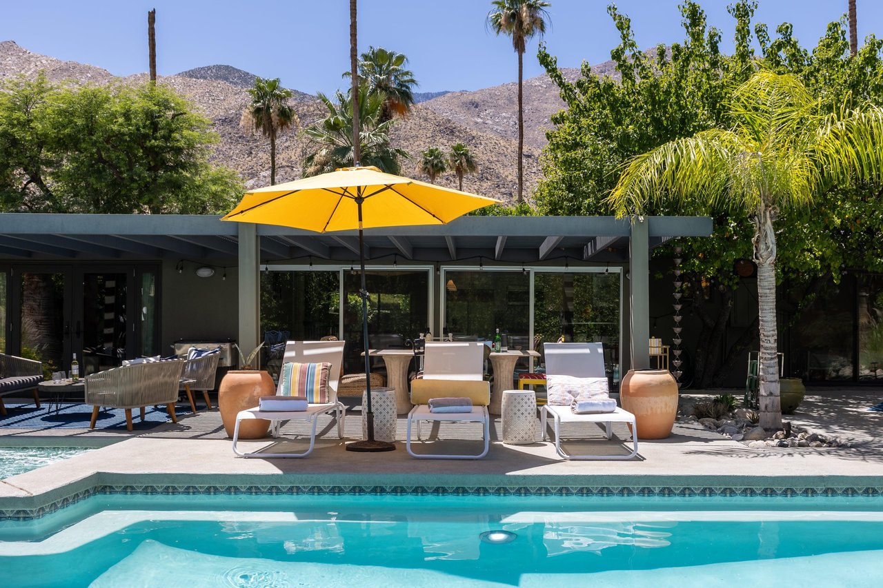 Entertainers backyard with outdoor seating, private pool and spa, sun loungers, cabana, and outdoor dining space.