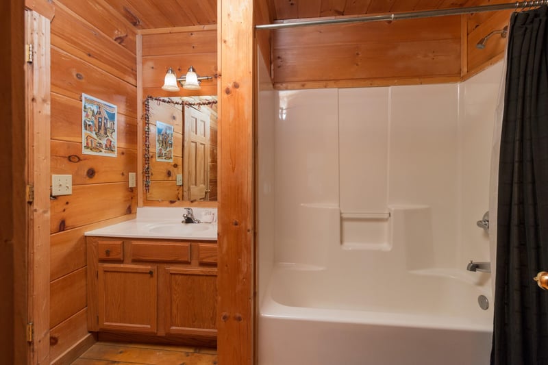 Bathroom with a tub and shower at Lumber Jack Lodge, a 1 bedroom cabin rental located in Gatlinburg