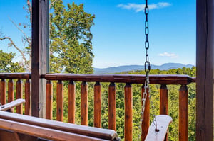 Step onto your private balcony and breathe in the fresh mountain air. A swing awaits, perfect for sipping morning coffee while soaking in sweeping views of rolling ridges and endless blue skies.