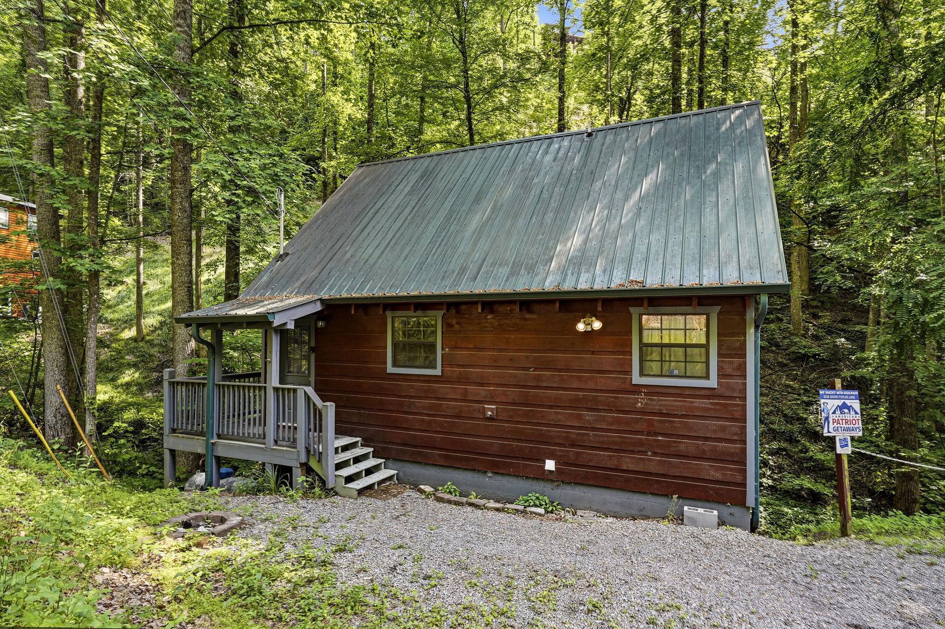 This cozy cabin nestled among towering trees offers a peaceful retreat surrounded by natures beauty and tranquility.