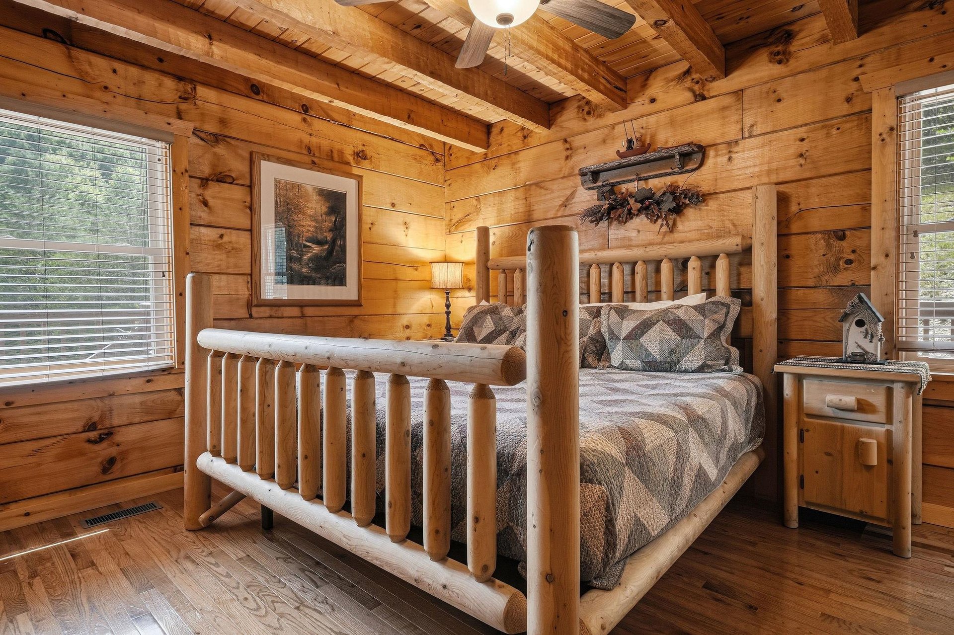 Sink into the rustic charm of this cozy bedroom, where a handcrafted log bed and warm wood surroundings invite your most peaceful mountain retreat dreams.
