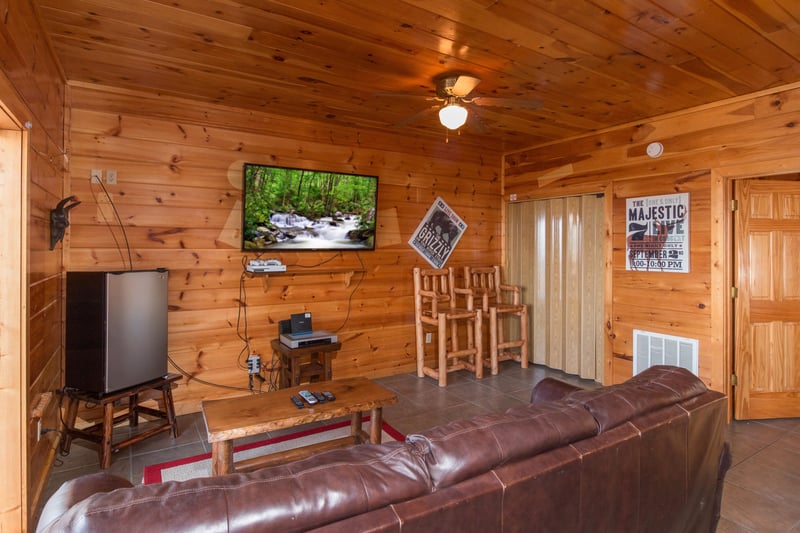 Mini fridge and large TV in the game room at EllaVation, a 3 bedroom cabin rental located in Gatlinburg