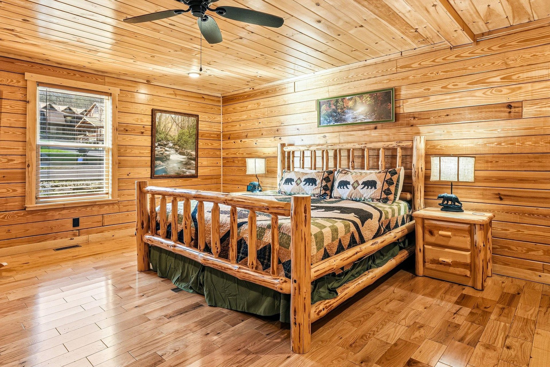 Drift off to sleep in this rustic log cabin bedroom where warm wood surrounds you and cozy bearthemed bedding awaits your arrival.