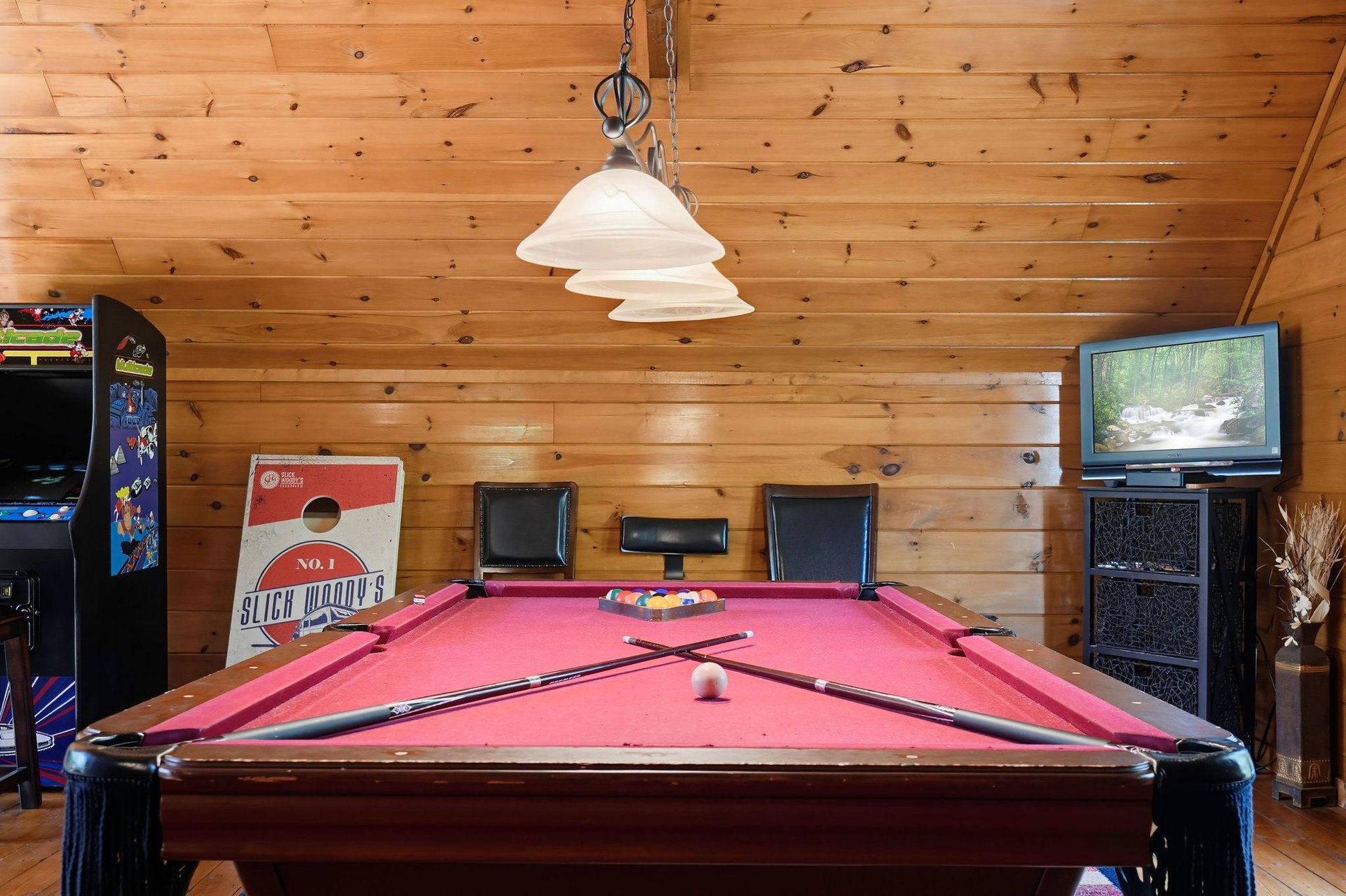 Challenge your friends to a friendly game of pool in the rustic game room, with vaulted wood ceilings and arcade entertainment for endless fun.