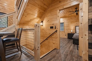 Step into this charming loft space where rustic wood beams and modern touches create your perfect mountain retreat sanctuary.