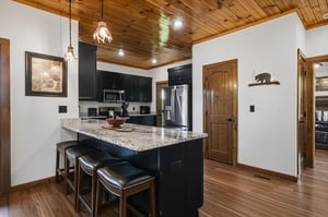 Gather around the island in your fully equipped kitchen, where granite countertops and stainless steel appliances set the stage for your mountain getaway meals. Warm wood ceilings and rustic touches c