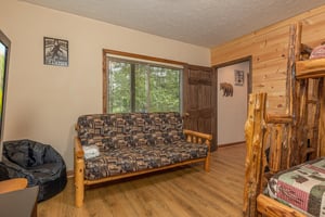 Bunk room with a futon at Cubs Crib, a 3 bedroom cabin rental located in Gatlinburg
