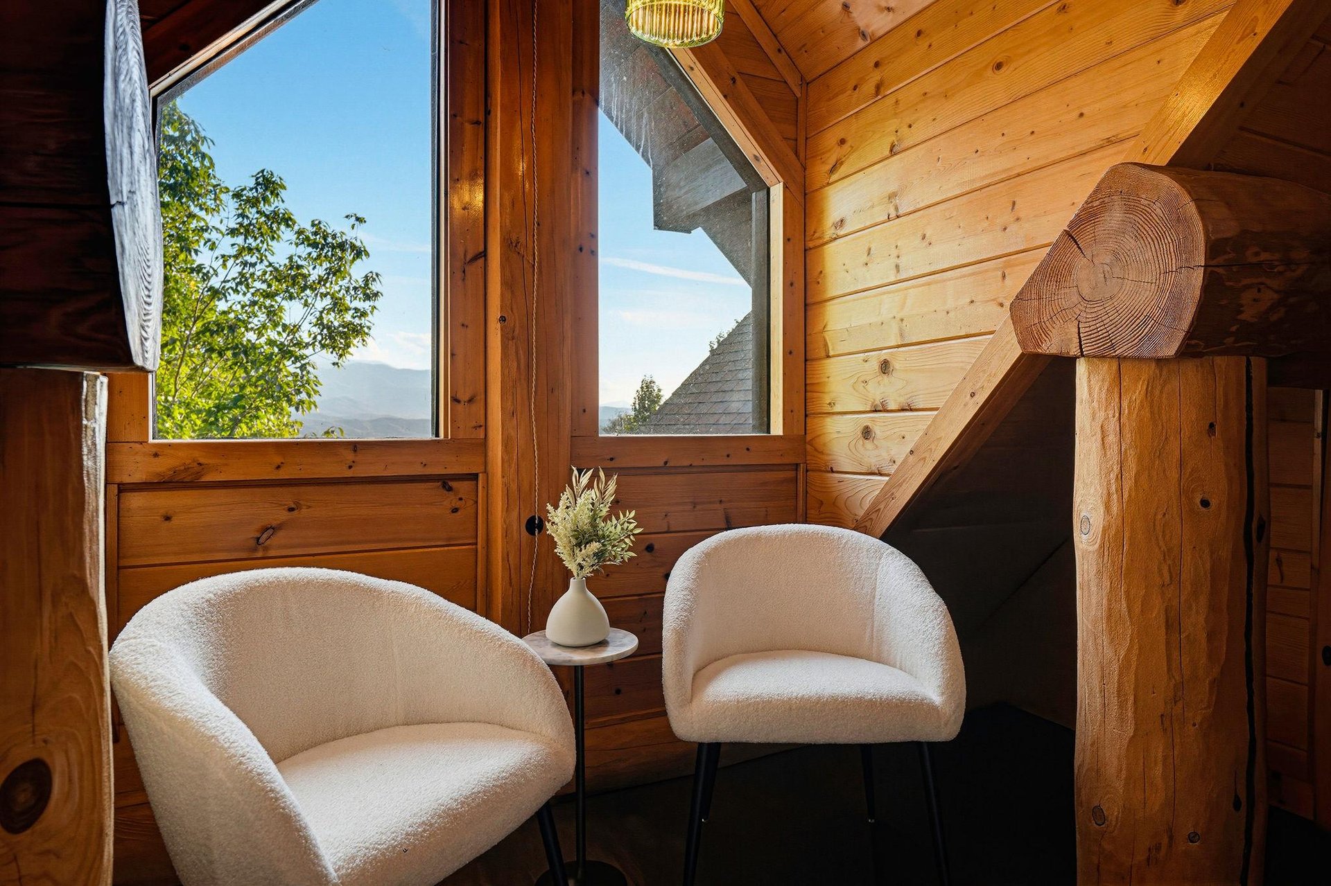 Settle into plush seating and gaze out at mountain and forest views through your cabins generous windows—a perfect spot to unwind with morning coffee or an evening chat.