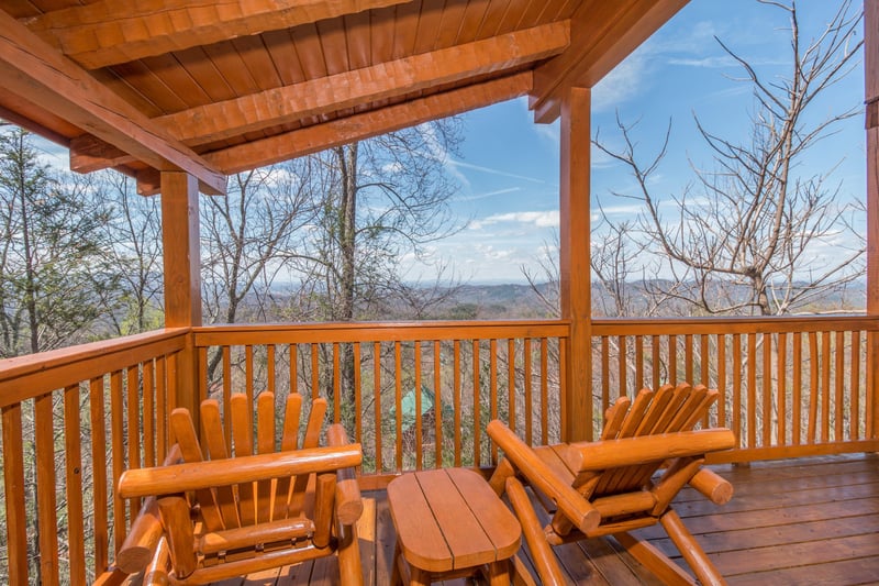 Deck with seasonal views and rocking chairs at EllaVation, a 3 bedroom cabin rental located in Gatlinburg