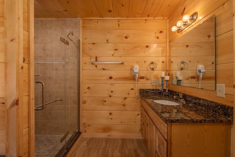 Walk in shower with single vanity sink