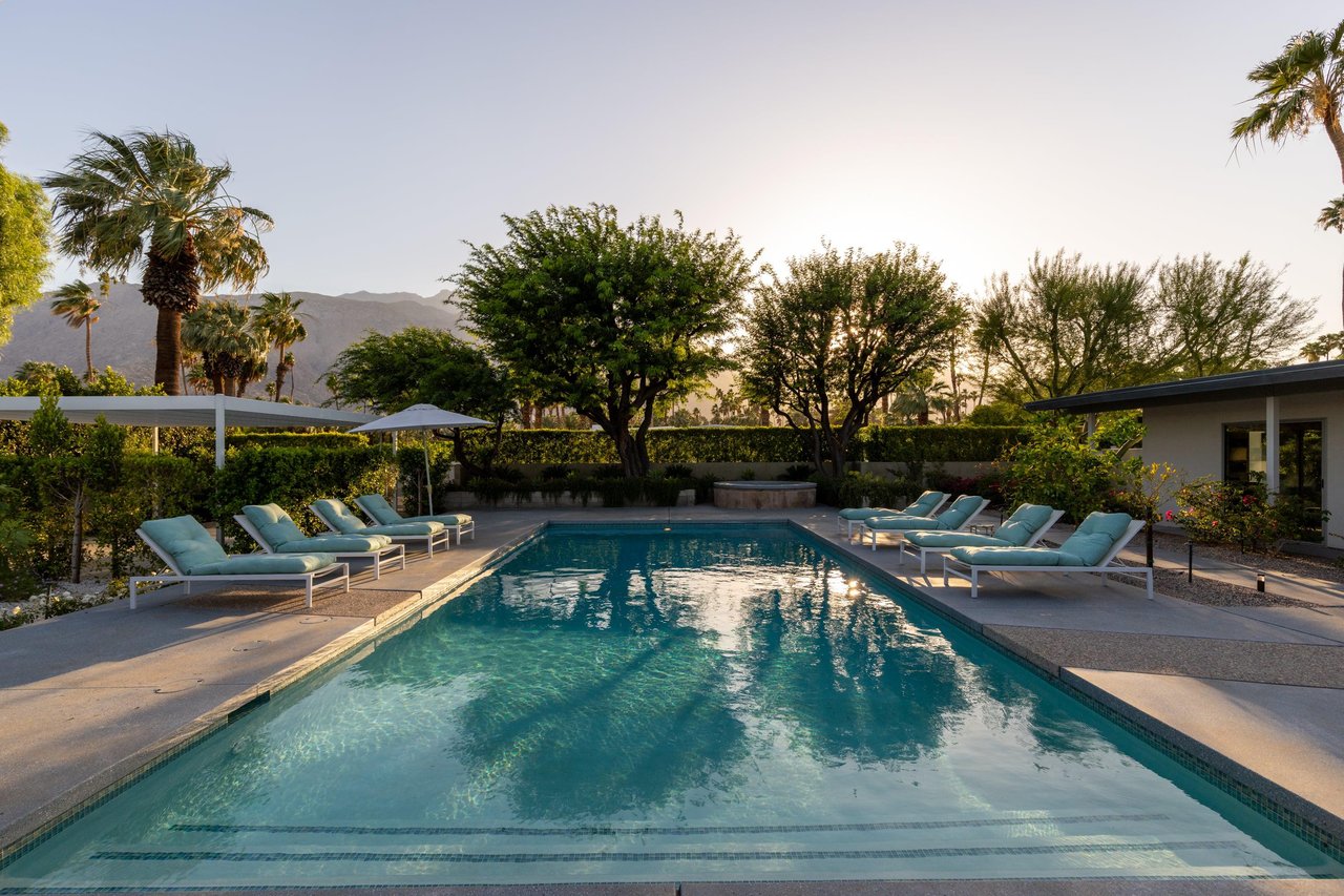 Private poolspa with sun loungers and umbrellas.