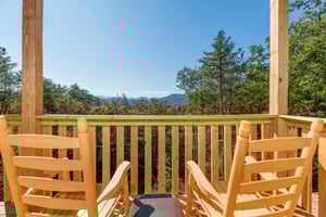 Rocking chairs and a mountain view at Canyon Camp Falls, a 2 bedroom cabin rental located in Pigeon Forge