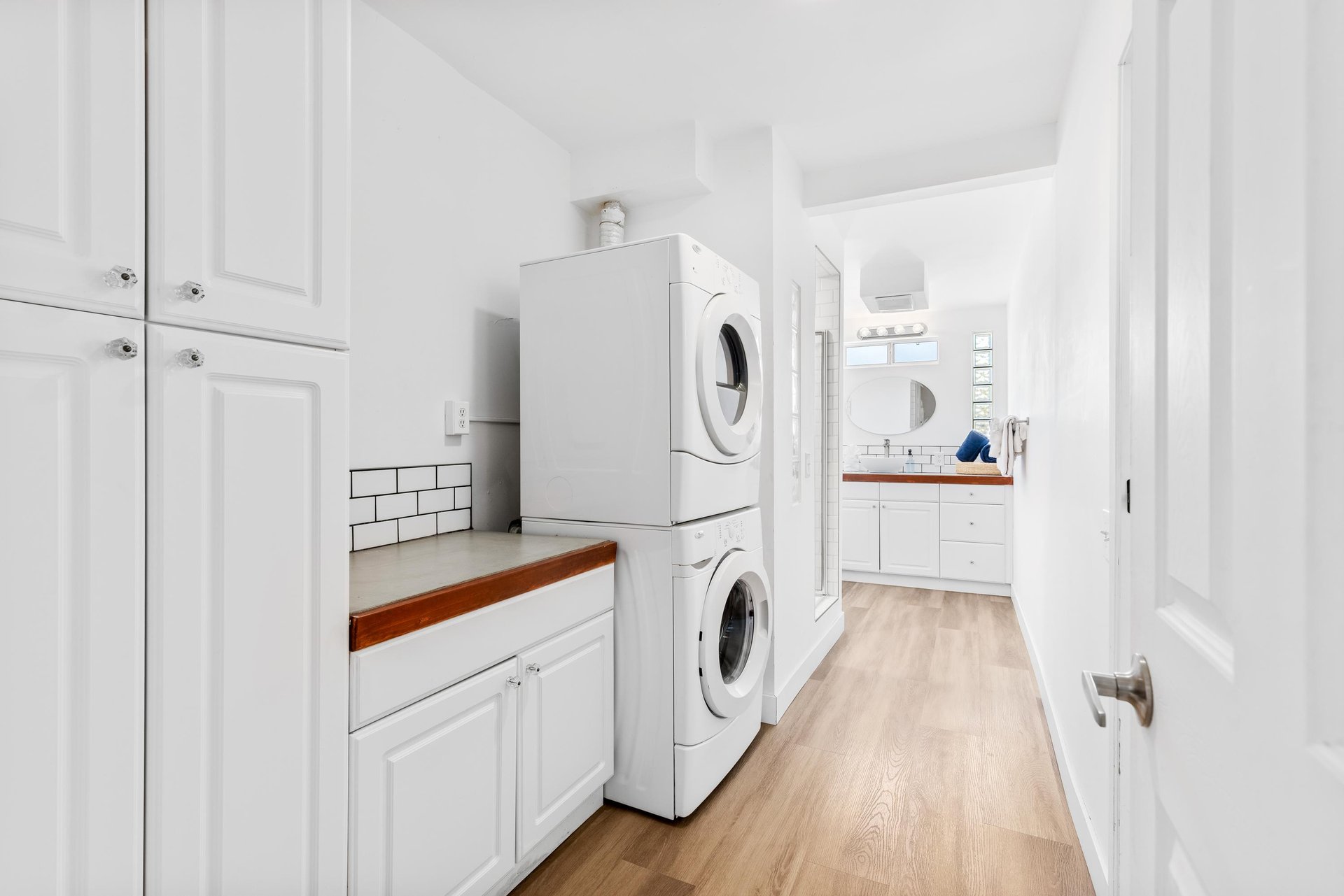 Guest bathroom with stand alone shower and washerdryer for guest use.