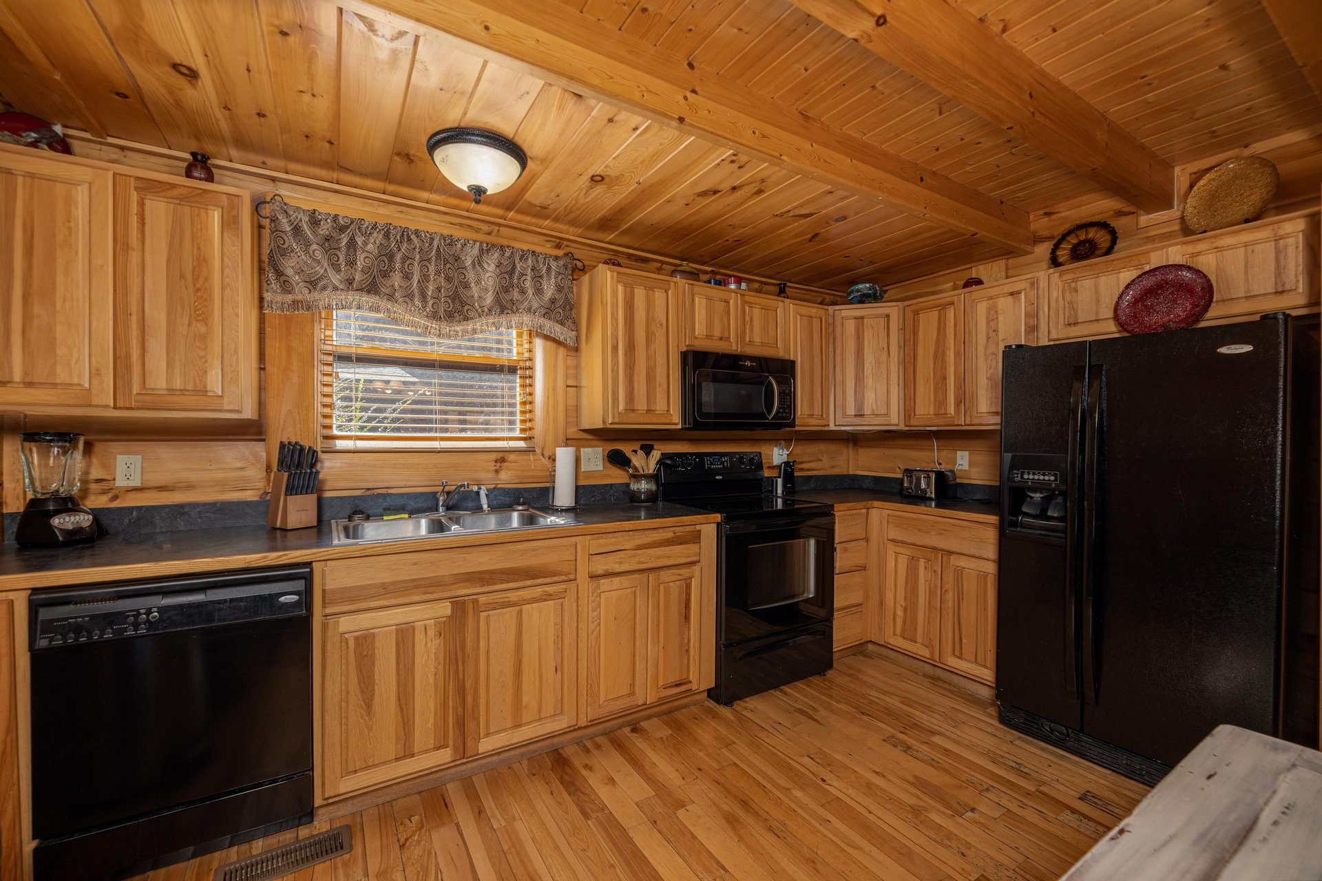 Kitchen with black appliances at Bears Dont Bluff, a 3 bedroom cabin rental located in Pigeon Forge