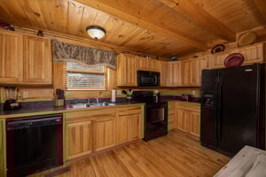 Kitchen with black appliances at Bears Dont Bluff, a 3 bedroom cabin rental located in Pigeon Forge