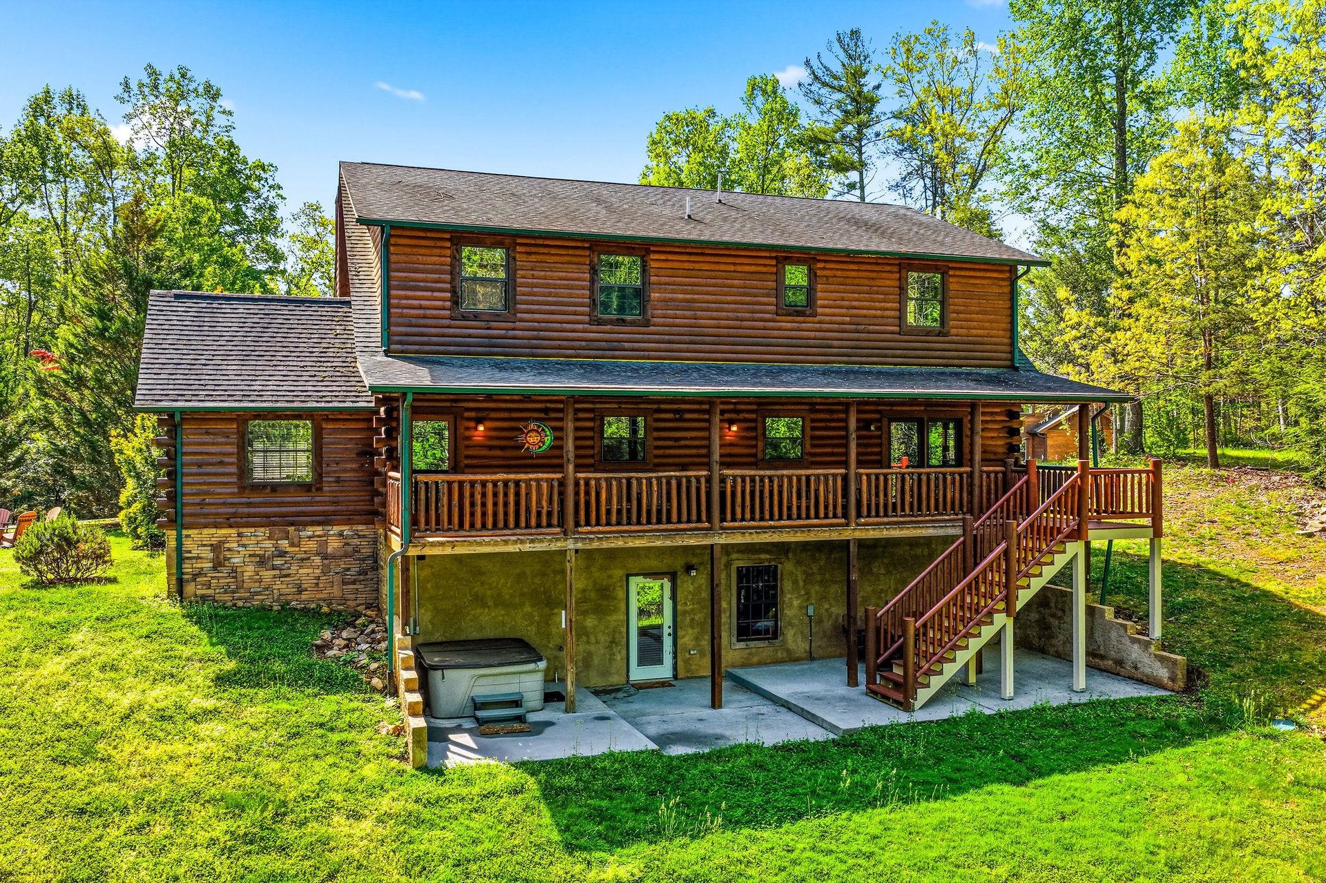 Beautiful twostory log cabin nestled among mature trees with spacious deck and peaceful forest surroundings for the perfect getaway retreat.