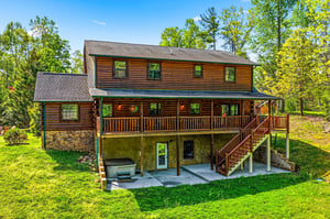 Beautiful twostory log cabin nestled among mature trees with spacious deck and peaceful forest surroundings for the perfect getaway retreat.