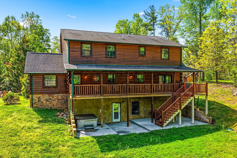Beautiful twostory log cabin nestled among mature trees with spacious deck and peaceful forest surroundings for the perfect getaway retreat.
