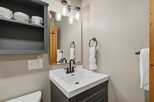 Your private bathroom features a sleek vanity, thoughtful storage, and crisp linens—everything you need to refresh after a day of adventure.