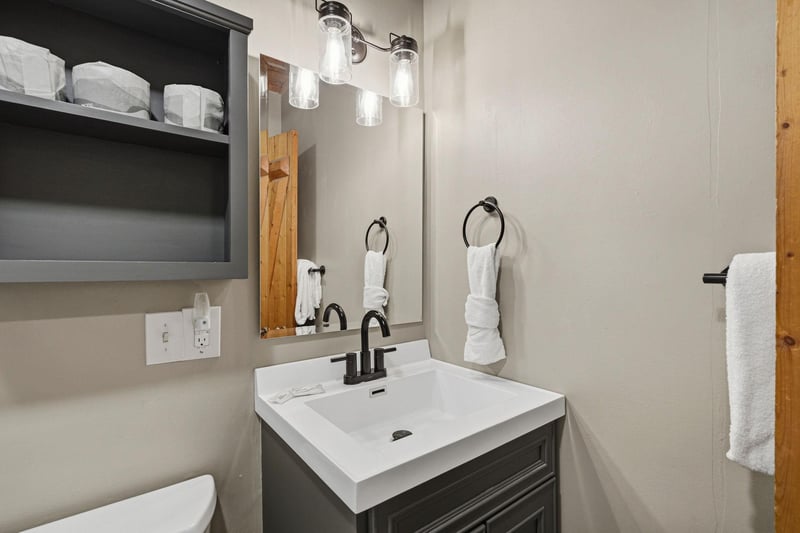 Your private bathroom features a sleek vanity, thoughtful storage, and crisp linens—everything you need to refresh after a day of adventure.