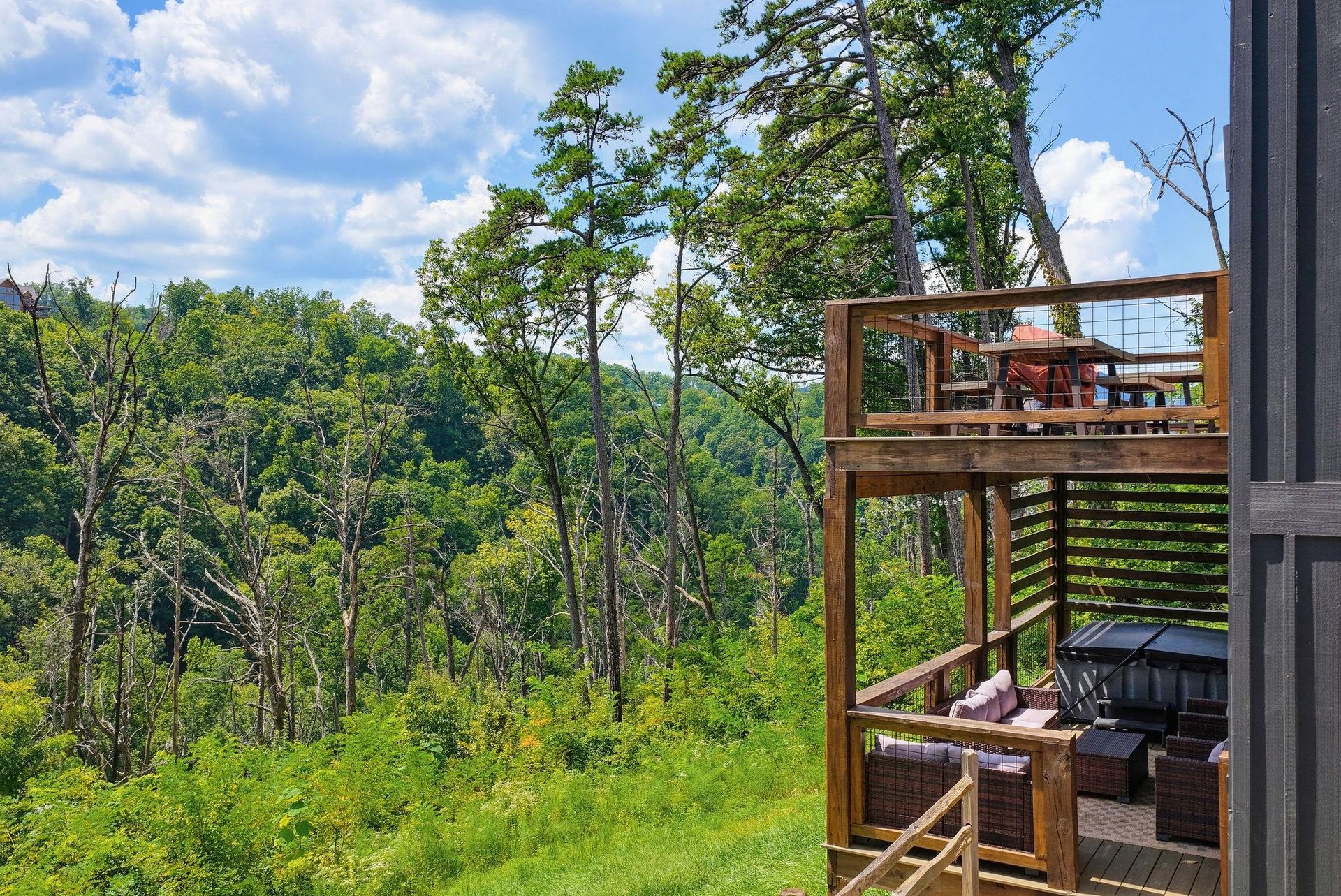 A peaceful woodland retreat with expansive forest views stretches out before you, where your private multilevel deck offers quiet moments beneath the trees and open sky.