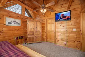 Armoire  TV in a bedroom at Livin Simple, a 2 bedroom cabin rental located in Pigeon Forge