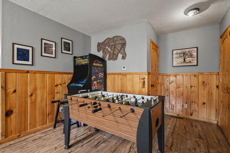 Challenge friends to foosball matches in your private game room, complete with arcade fun and rustic mountain charm.