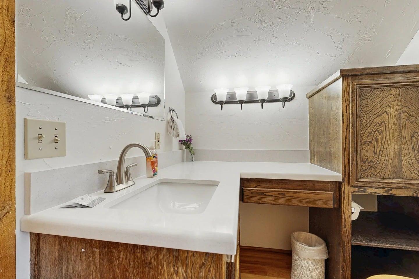 A clean, updated vanity with plenty of counter space, tucked just off the shared upstairs bathroom.