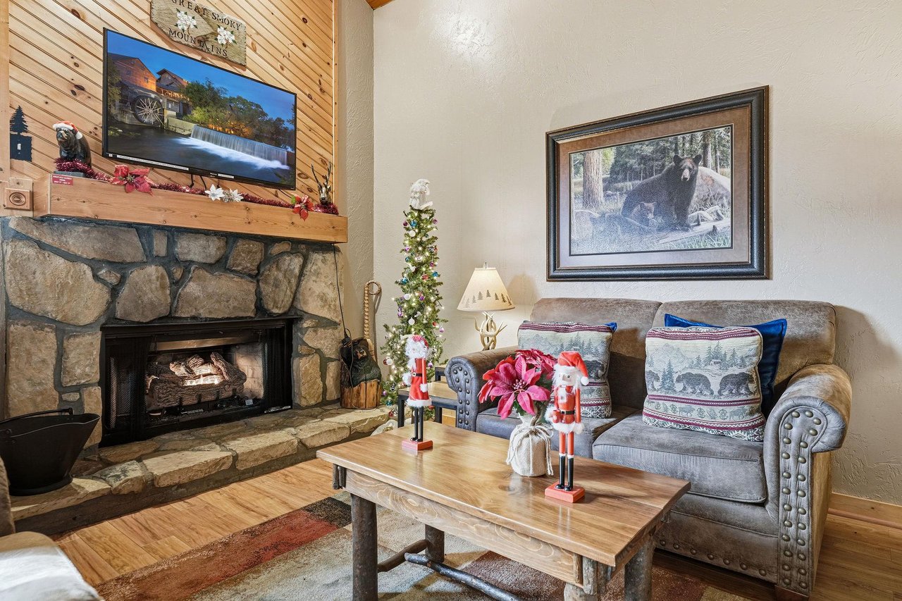 Cozy up by your stone fireplace with holiday decorations creating magical warmth for memorable evenings.