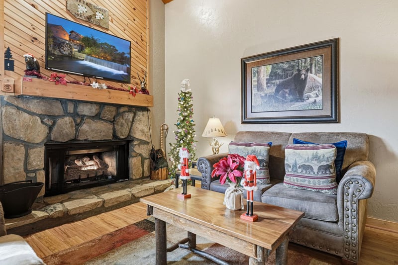 Cozy up by your stone fireplace with holiday decorations creating magical warmth for memorable evenings.