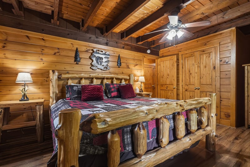 Sink into the rustic charm of your logframed bed beneath soaring wooden beams, where warm lighting and cozy linens invite you to unwind in true cabin style.