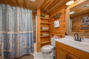 Your rustic log cabin bathroom combines country charm with modern comfort, featuring warm wood walls and thoughtful storage.