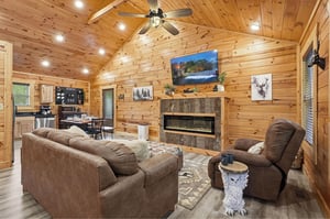 Curl up in plush seating beside the crackling fireplace, where vaulted woodbeamed ceilings and rustic charm create your perfect mountain retreat for cozy evenings together.