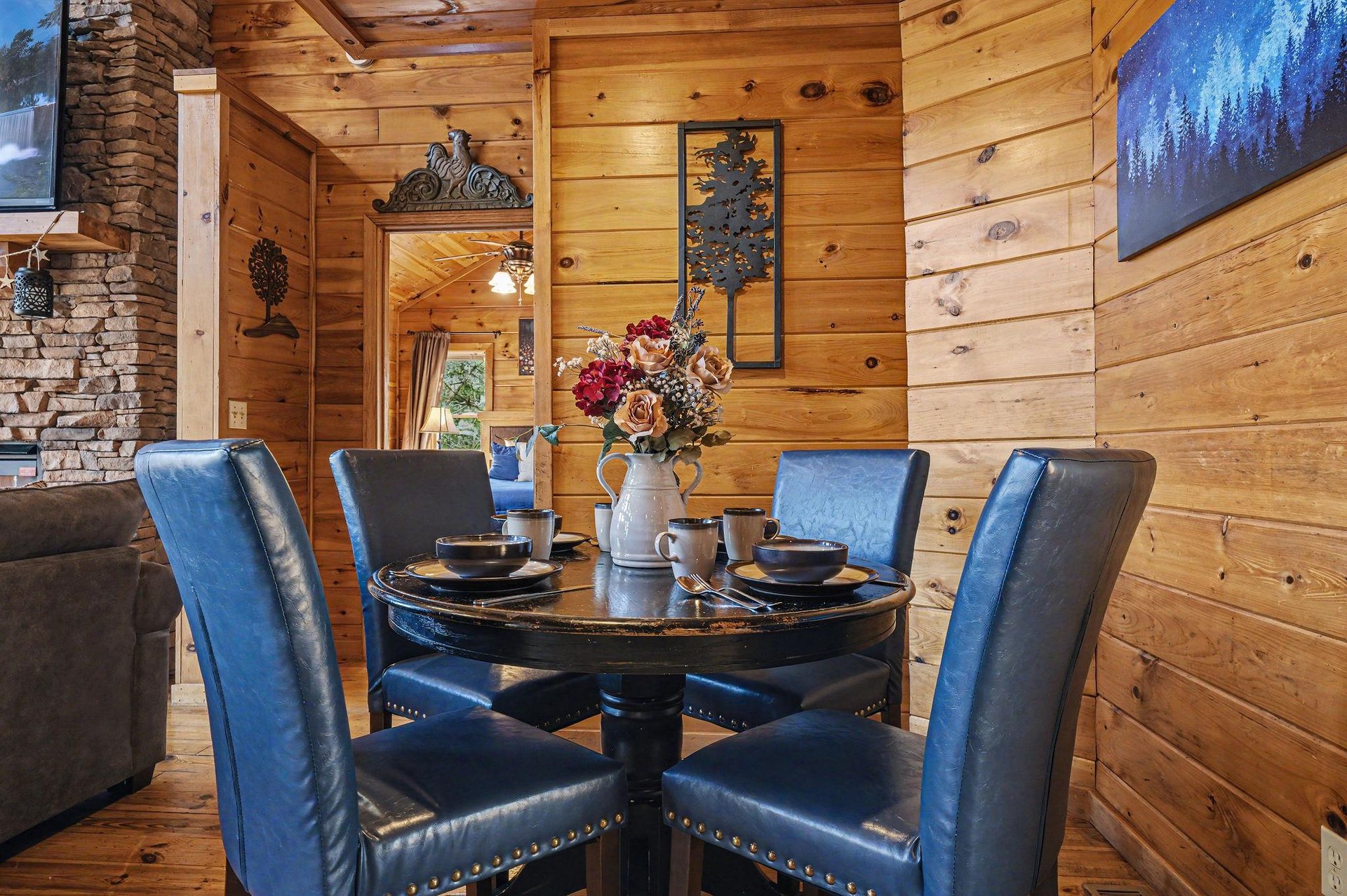 Gather around your elegant dining table surrounded by warm log cabin charm and rustic mountain decor.