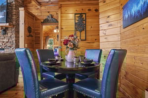 Gather around your elegant dining table surrounded by warm log cabin charm and rustic mountain decor.