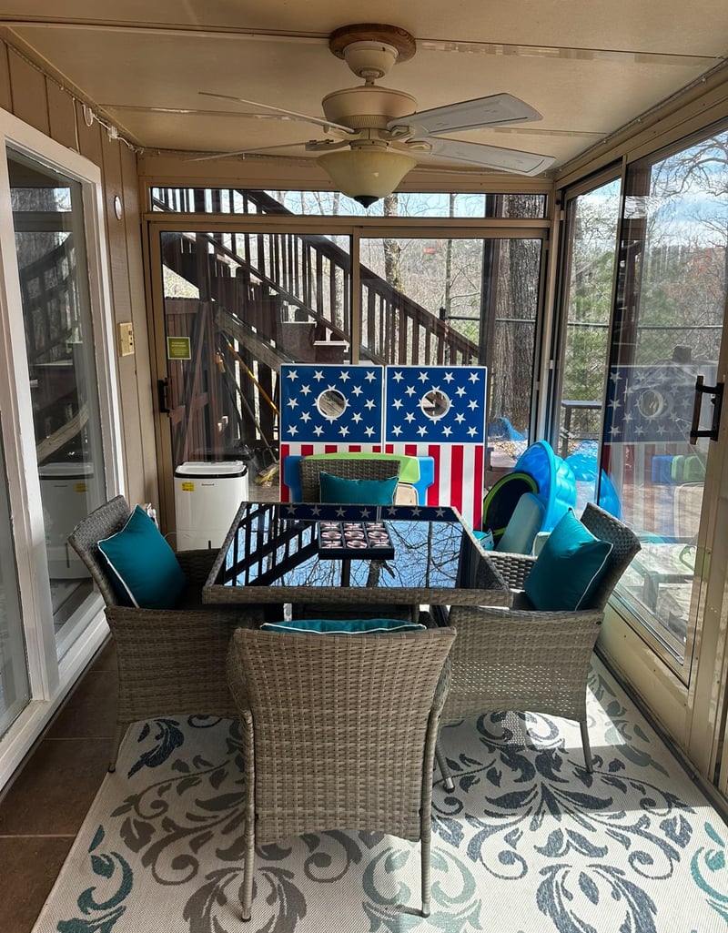 Seating area on screened in porch at Buena Vista Getaway, 3 bedroom cabin rental located in Gatlinburg