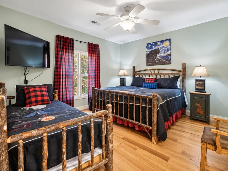 Unwind in your cozy bedroom with rustic log furnishings, soft bedding, and a ceiling fan to keep you comfortable after a day of exploring.