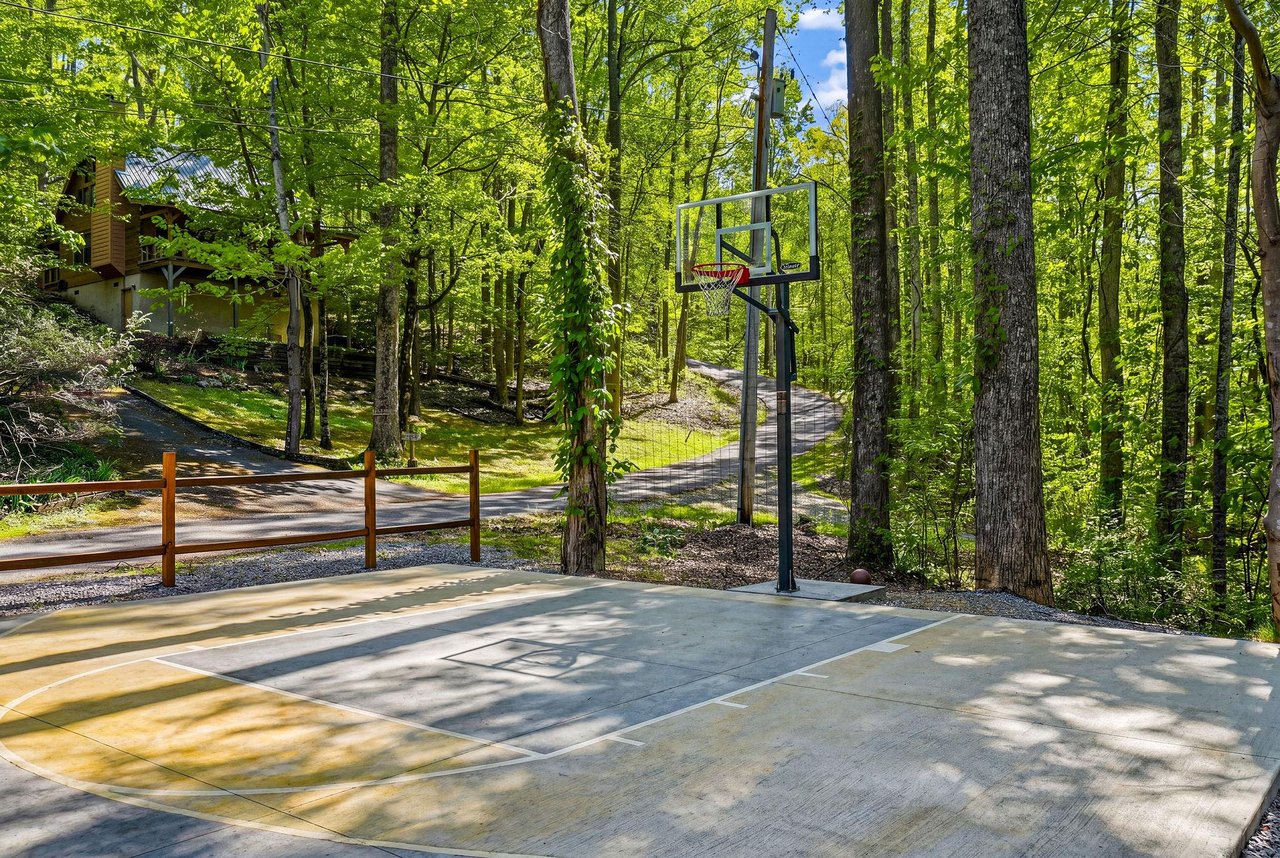 Shoot hoops on your private basketball court surrounded by towering trees and peaceful forest views.