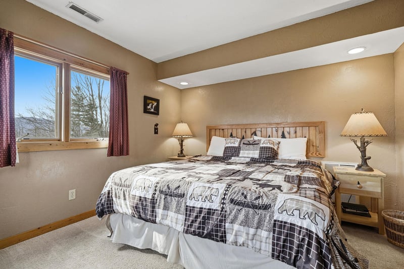 Sink into your cozy king bed with rustic charm and mountain views streaming through your private window.